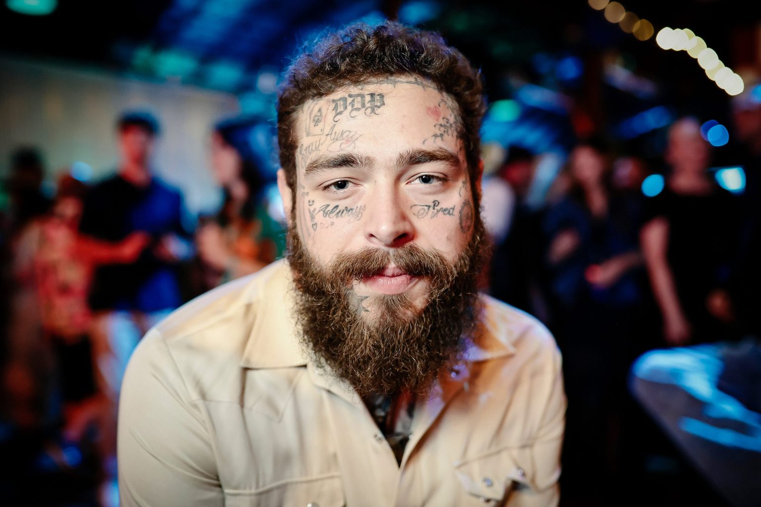 Post Malone attending the Road House world premiere, showcasing his eclectic style and persona